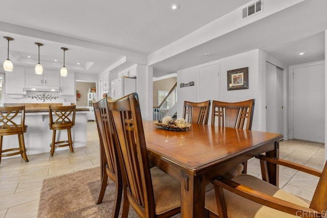 dining space featuring a raised ceiling, recessed lighting, light tile patterned flooring, and visible vents