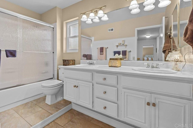 bathroom featuring a sink, tile patterned floors, double vanity, and visible vents