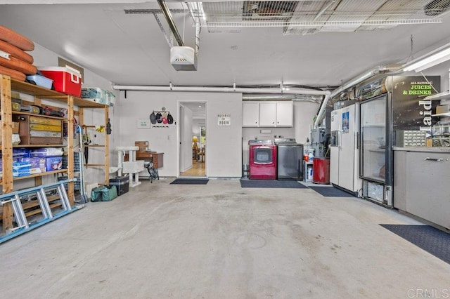 garage featuring separate washer and dryer and a garage door opener