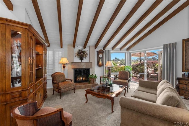 living area featuring lofted ceiling with beams, plenty of natural light, and carpet