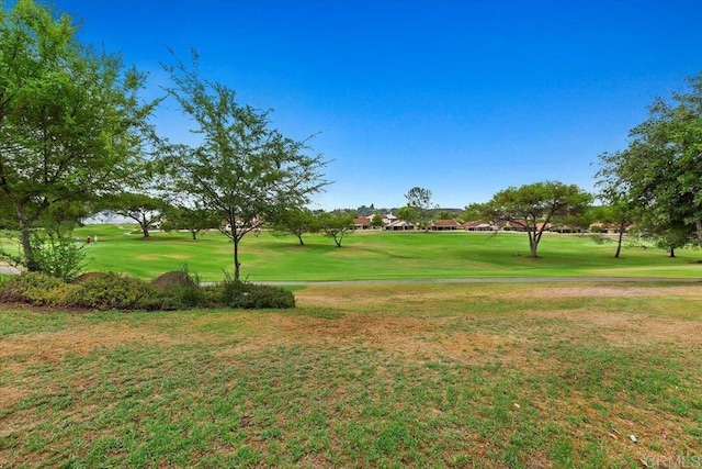surrounding community with a lawn and golf course view