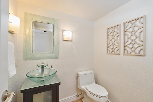 1719 Willowhaven Rd, Encinitas, CA 92024 - half bathroom featuring toilet, baseboards, and vanity