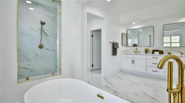 bathroom featuring a freestanding tub, vanity, a marble finish shower, and marble finish floor