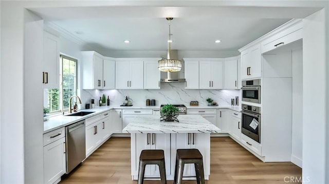kitchen with a kitchen island, stainless steel appliances, decorative backsplash, and a sink