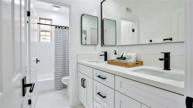 full bath with double vanity, toilet, visible vents, and a sink