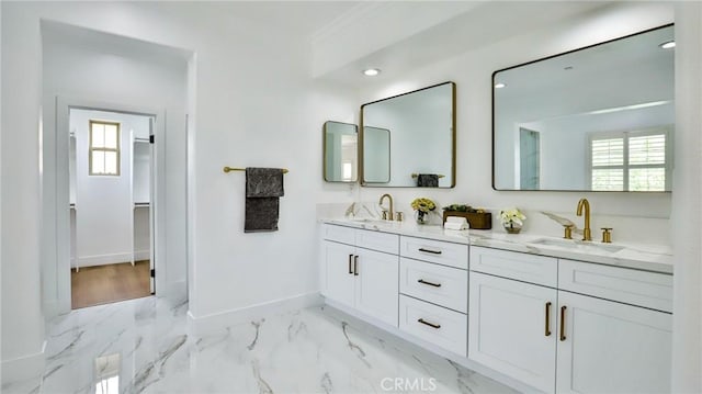 full bathroom featuring a sink, baseboards, and a healthy amount of sunlight