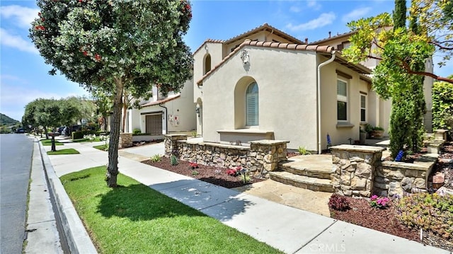 mediterranean / spanish-style home featuring stucco siding