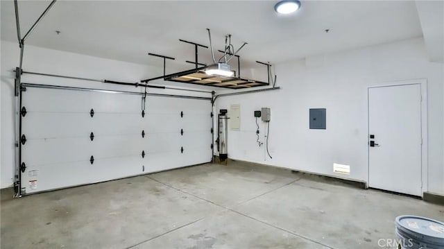 garage with a garage door opener and electric panel