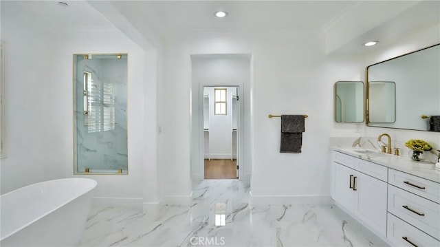 bathroom with vanity, marble finish floor, recessed lighting, baseboards, and a freestanding tub