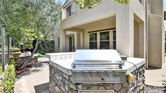 view of patio / terrace with a balcony and a grill