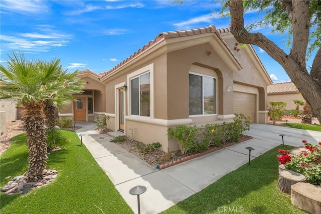 37388 Medjool, Palm Desert, CA 92211 - view of property exterior with stucco siding, an attached garage, driveway, and a tile roof