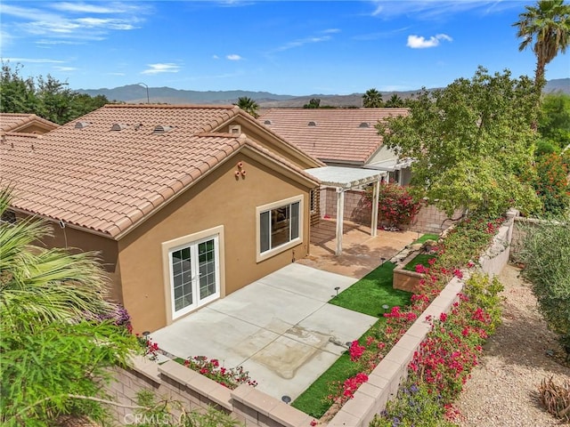 37388 Medjool, Palm Desert, CA 92211 - rear view of house with a pergola, stucco siding, a mountain view, a patio area, and a tiled roof