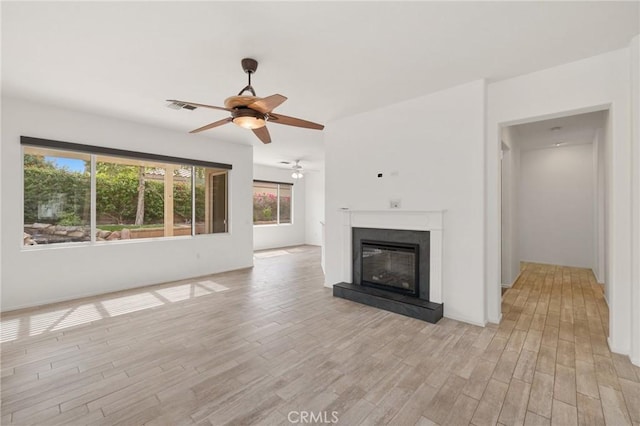 37388 Medjool, Palm Desert, CA 92211 - unfurnished living room with ceiling fan, light wood finished floors, and a glass covered fireplace