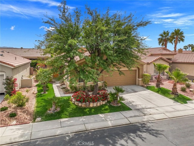 37388 Medjool, Palm Desert, CA 92211 - view of front of house featuring concrete driveway, a garage, a tile roof, stucco siding, and a front lawn