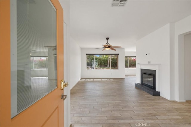 37388 Medjool, Palm Desert, CA 92211 - unfurnished living room featuring ceiling fan, light wood finished floors, and a glass covered fireplace