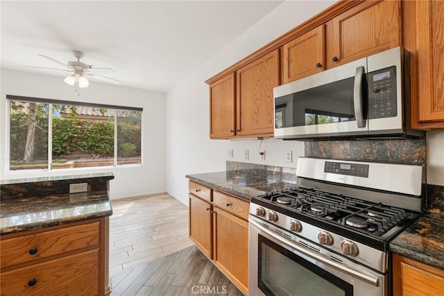 37388 Medjool, Palm Desert, CA 92211 - kitchen with appliances with stainless steel finishes, brown cabinetry, a ceiling fan, and light wood-style flooring