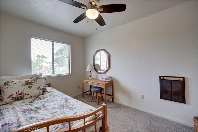 carpeted bedroom featuring baseboards and ceiling fan