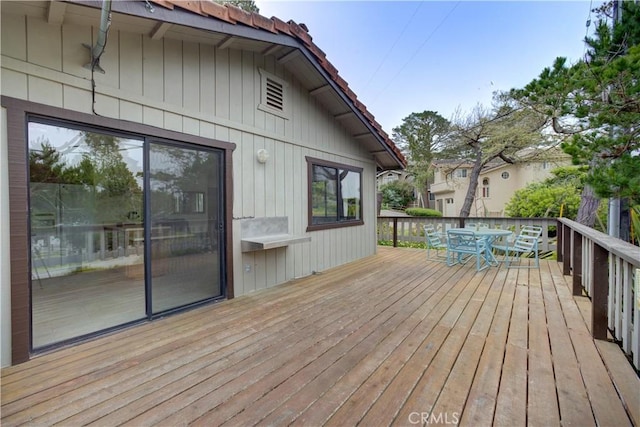 wooden terrace with outdoor dining area