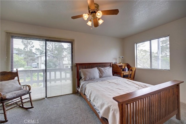 bedroom featuring carpet floors, a ceiling fan, and a textured ceiling
