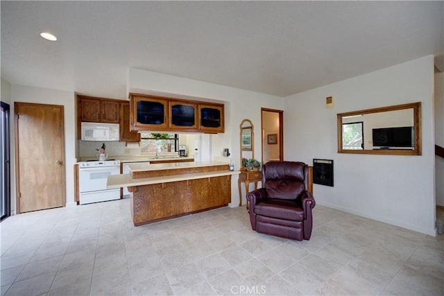 kitchen with light countertops, a peninsula, white appliances, and a wealth of natural light