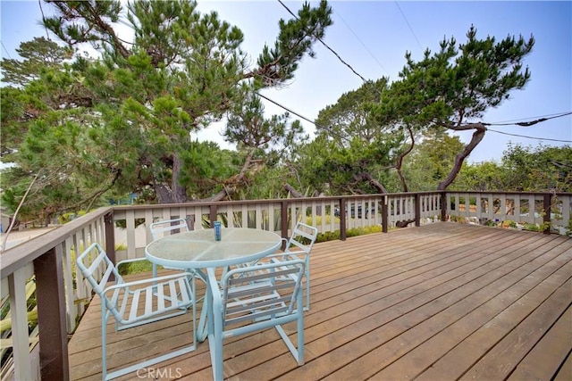 wooden terrace featuring outdoor dining area