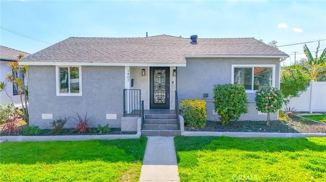 1402 E Luray St, Long Beach, CA 90807 - bungalow-style house featuring a shingled roof, stucco siding, and a front lawn