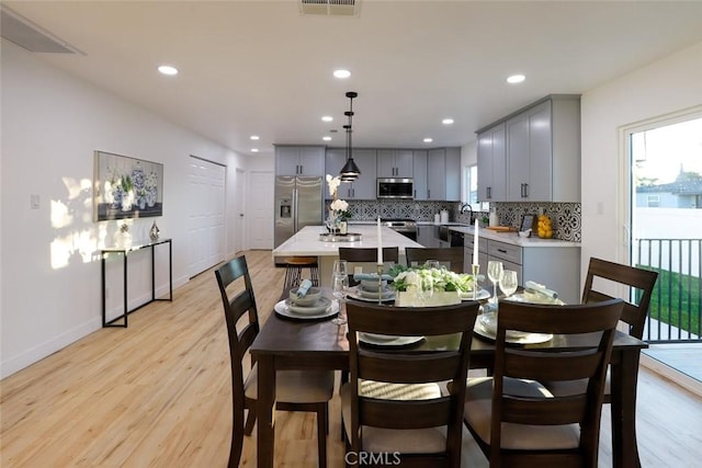 1402 E Luray St, Long Beach, CA 90807 - dining room with baseboards, light wood finished floors, and a wealth of natural light