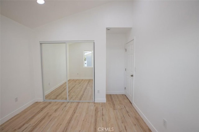 1402 E Luray St, Long Beach, CA 90807 - unfurnished bedroom with baseboards, wood finished floors, lofted ceiling, and a closet