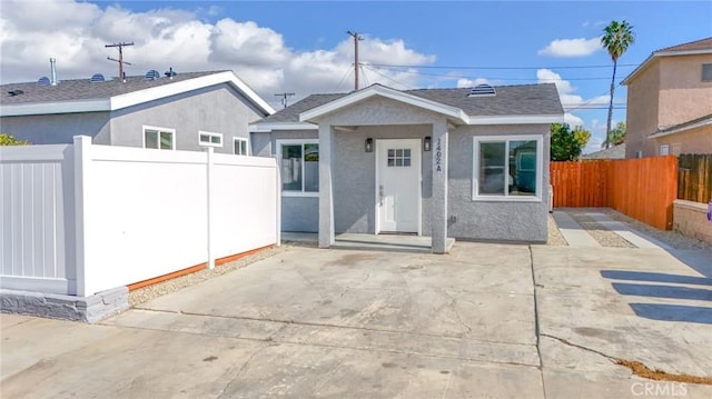 1402 E Luray St, Long Beach, CA 90807 - view of front facade featuring fence, a patio area, and stucco siding
