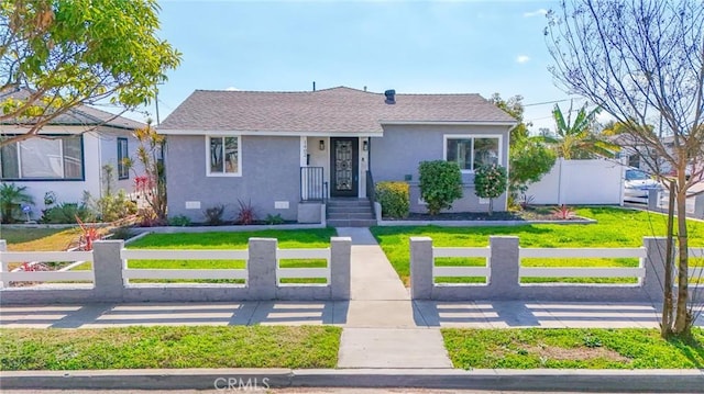1402 E Luray St, Long Beach, CA 90807 - view of front of house featuring a fenced front yard, stucco siding, a front yard, and roof with shingles