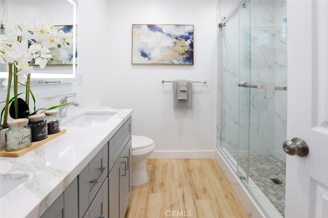 1402 E Luray St, Long Beach, CA 90807 - full bath with vanity, wood finished floors, toilet, baseboards, and a marble finish shower