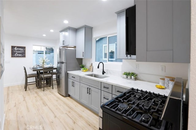 1402 E Luray St, Long Beach, CA 90807 - kitchen featuring a sink, gas stove, freestanding refrigerator, and gray cabinetry