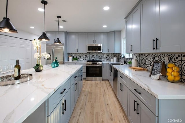 1402 E Luray St, Long Beach, CA 90807 - kitchen with gray cabinetry, appliances with stainless steel finishes, a sink, and light wood-style floors