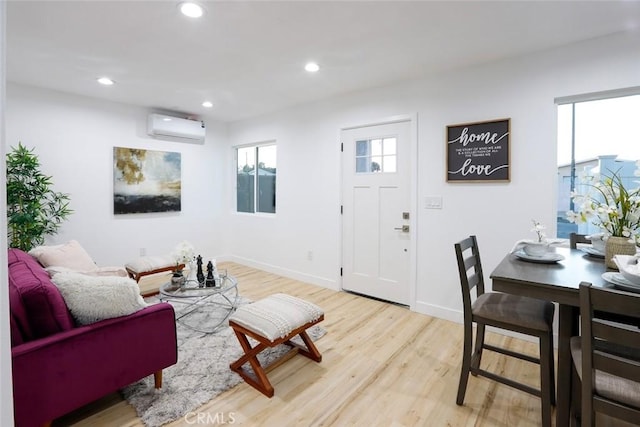 1402 E Luray St, Long Beach, CA 90807 - living area with light wood-style floors, a wall mounted air conditioner, baseboards, and recessed lighting