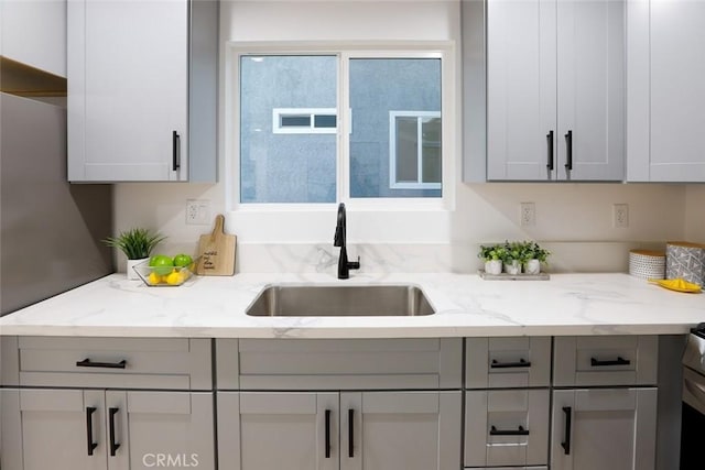 1402 E Luray St, Long Beach, CA 90807 - kitchen with a sink, light stone countertops, and gray cabinetry