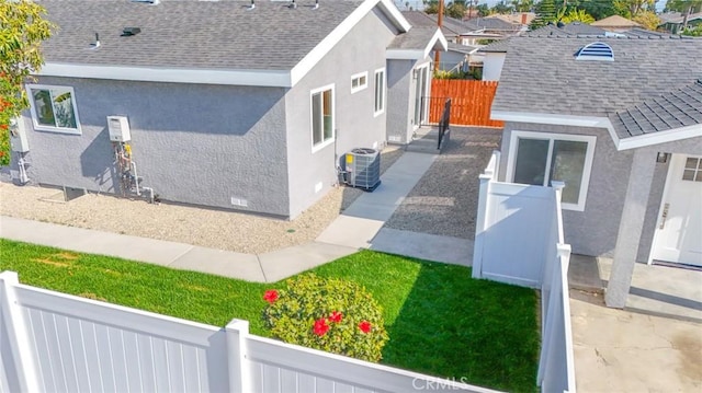 1402 E Luray St, Long Beach, CA 90807 - view of side of home featuring central AC unit, stucco siding, a shingled roof, and fence