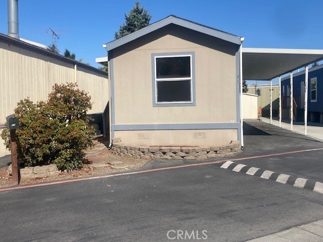 1885 E Bayshore Rd Unit 71, East Palo Alto, CA 94303 - view of home's exterior with crawl space, driveway, and an attached carport