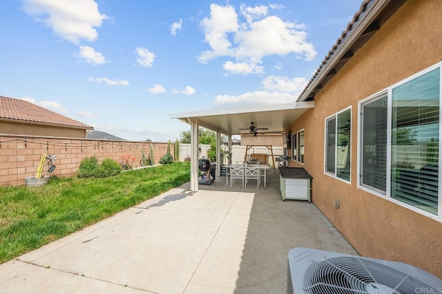 view of patio featuring a fenced backyard, ceiling fan, and central AC