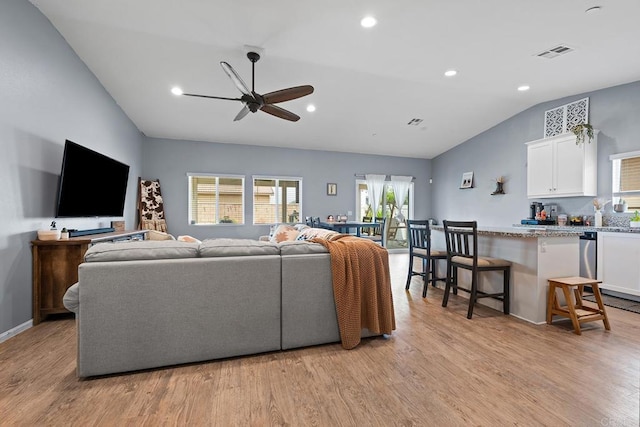 living area with recessed lighting, a ceiling fan, light wood-style flooring, and lofted ceiling