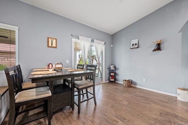 dining area with baseboards and wood finished floors