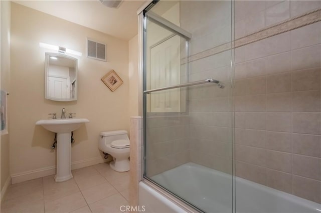 bathroom with tile patterned flooring, toilet, enclosed tub / shower combo, baseboards, and visible vents
