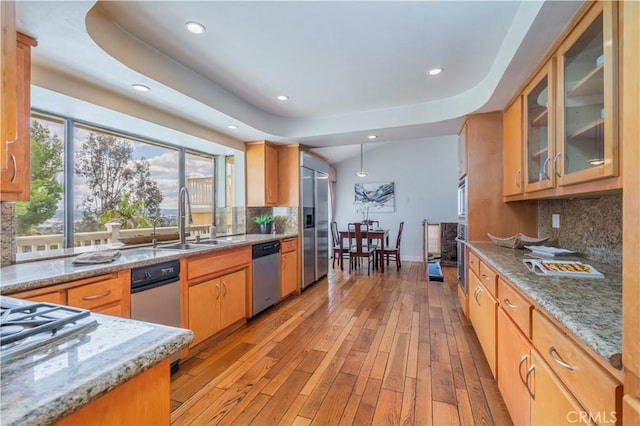 kitchen featuring recessed lighting, a sink, appliances with stainless steel finishes, and tasteful backsplash
