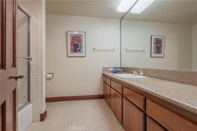 full bath featuring baseboards, tile patterned floors, bath / shower combo with glass door, and vanity