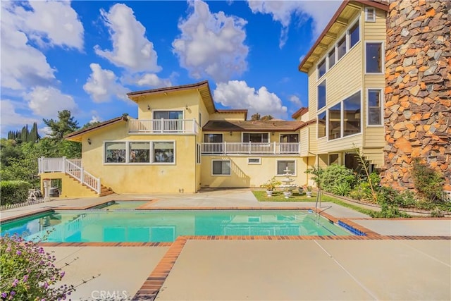 pool featuring a patio and stairway