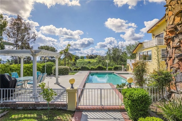 outdoor pool with a pergola, fence, and a patio area