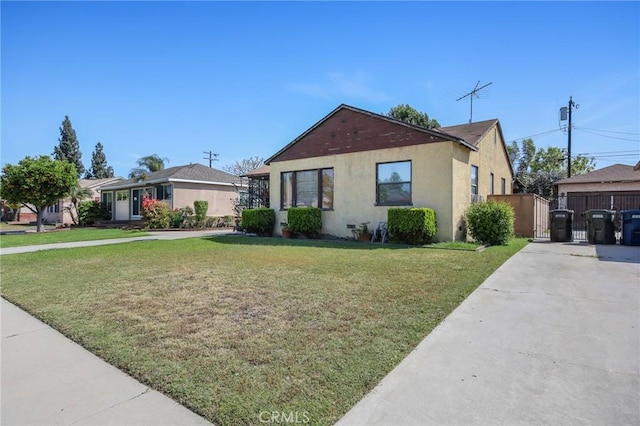 9706 Nan St, Pico Rivera, CA 90660 - view of front of house with a front lawn, a gate, stucco siding, and driveway