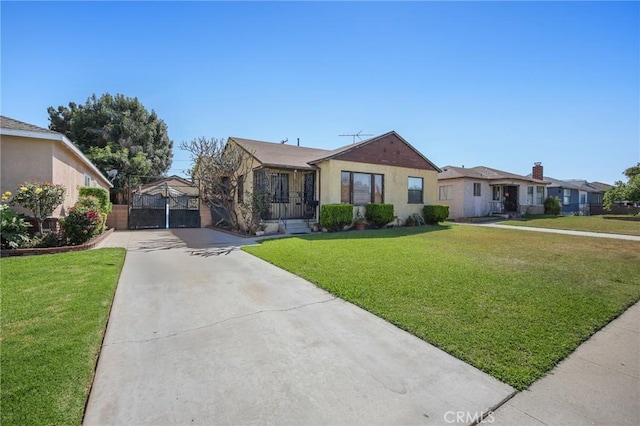9706 Nan St, Pico Rivera, CA 90660 - view of front of house featuring concrete driveway, a front lawn, and a gate