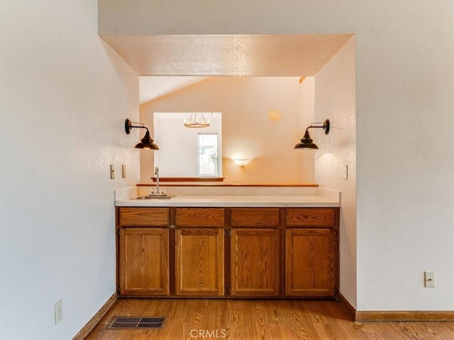 6405 Fiddleneck Ln, Avila Beach, CA 93424 - bathroom featuring wood finished floors, vaulted ceiling, vanity, and baseboards