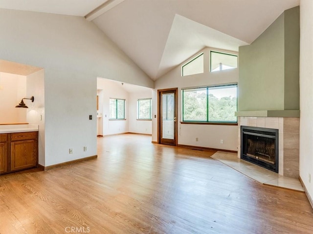6405 Fiddleneck Ln, Avila Beach, CA 93424 - unfurnished living room with a fireplace, light wood-type flooring, baseboards, high vaulted ceiling, and beam ceiling