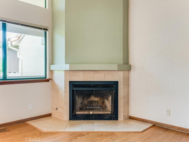 6405 Fiddleneck Ln, Avila Beach, CA 93424 - detailed view of a tile fireplace, wood finished floors, and baseboards